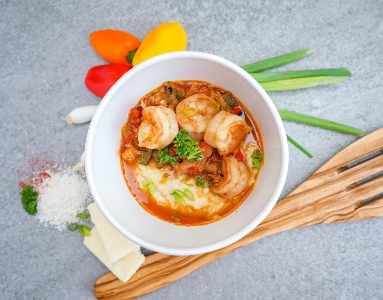 Shrimp and White Cheddar Grits with Herb Infused Butter, Creole Vegetables, and Lump Crab Meat