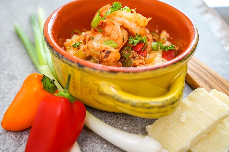 Shrimp and White Cheddar Grits with Herb Infused Butter, Creole Vegetables, and Lump Crab Meat