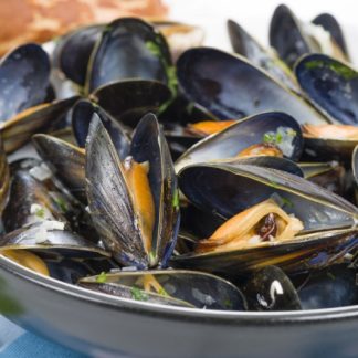 a bowl of cooked black mussels
